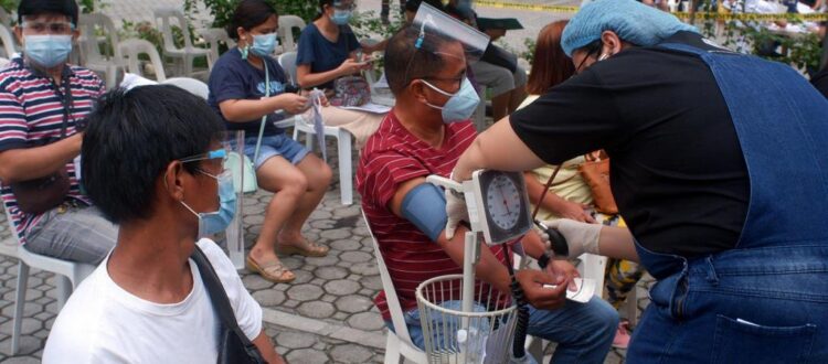 A group of medical volunteers from VMCLF providing free medical check-ups to residents of a community in Davao City, Philippines.